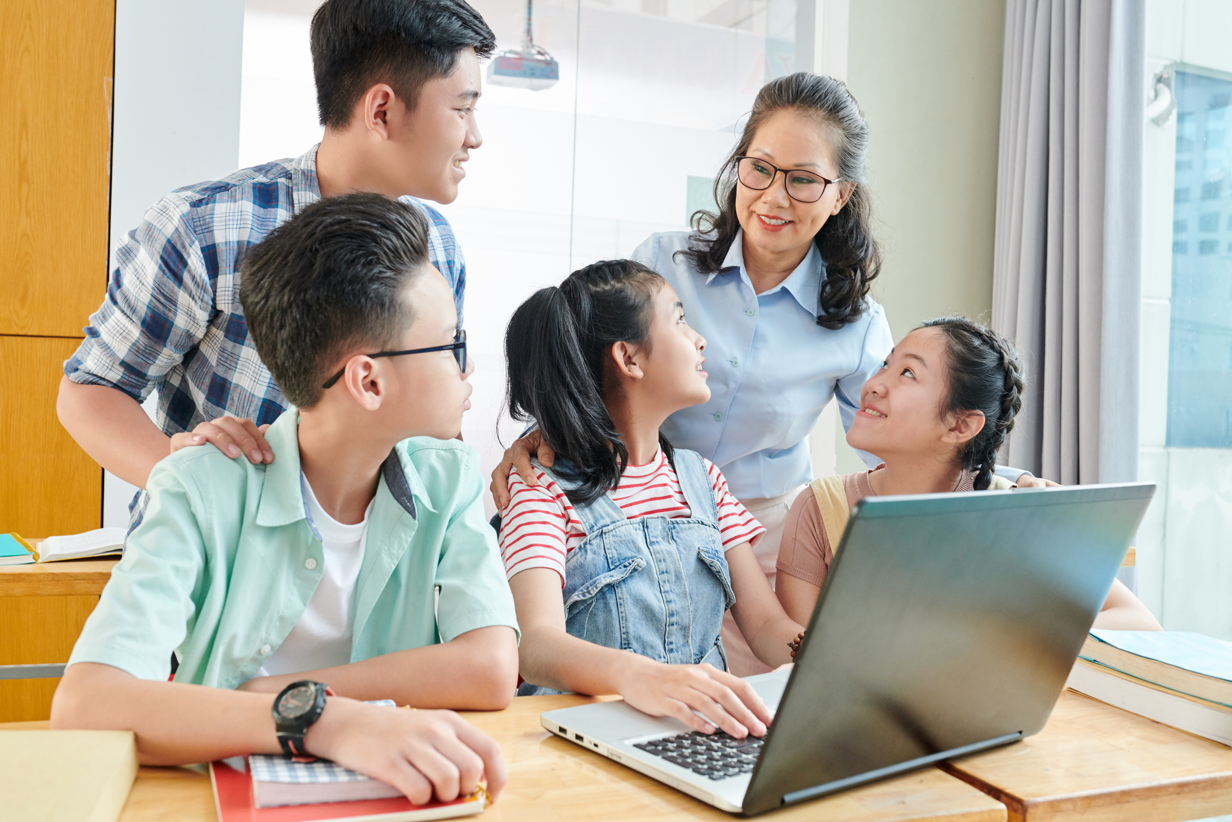 Students and Teacher Discussing Computer Program